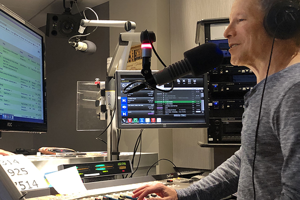 DJ Mark Hyken at the control board in the studio.